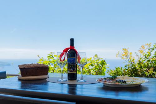 a bottle of wine and two glasses on a table at Villa Rustique in Budva