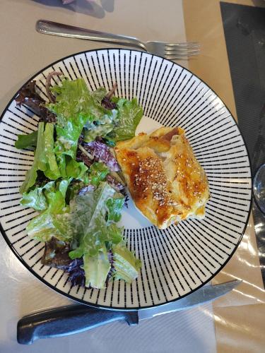 a plate of food with a salad on a table at Séjour Détente près de Bayeux au Calme avec Massages et repas in Tilly-sur-Seulles
