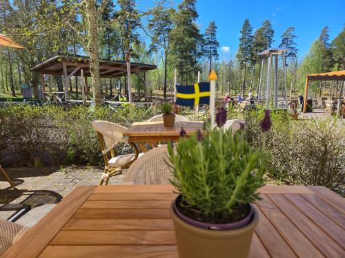 a wooden table with plants on it with a playground at Norrqvarn Hotel & Resort by Vänerport in Lyrestad