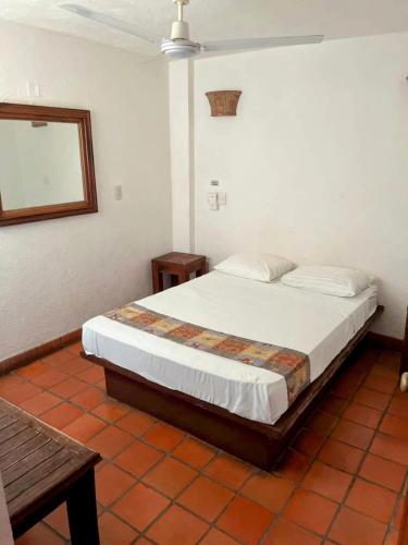 a bedroom with a large bed in a room at Casa Shaguibá in Santa Cruz Huatulco