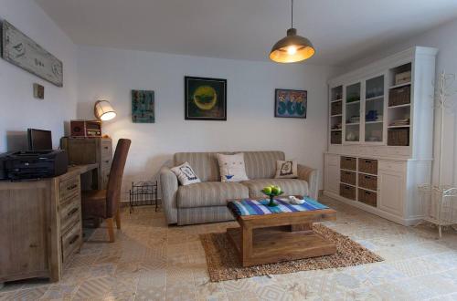 a living room with a couch and a table at Krk Houses in Kornić