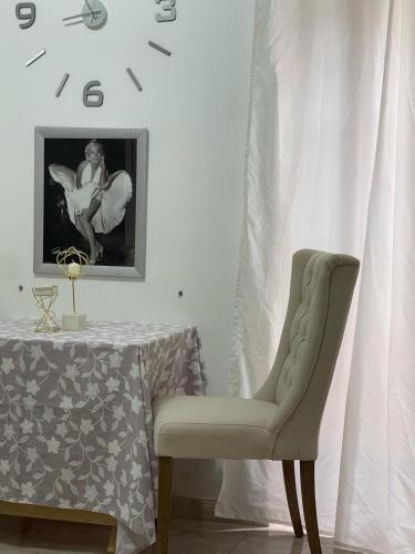a chair sitting next to a table in a room at Rory House in Pontecorvo