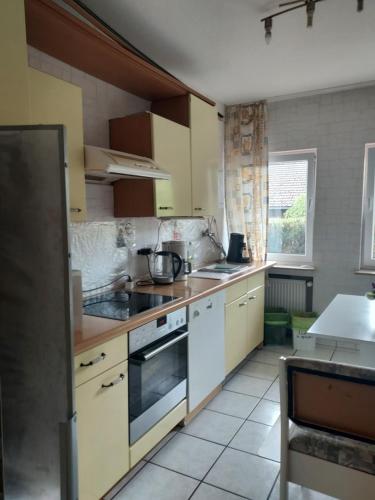 a kitchen with white cabinets and a stove top oven at FERIENWOHNUNG Marina in Bad Ems