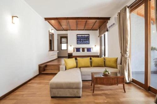 a living room with a couch and a table at Hibiscus Beach Hotel & Villas in Kalutara