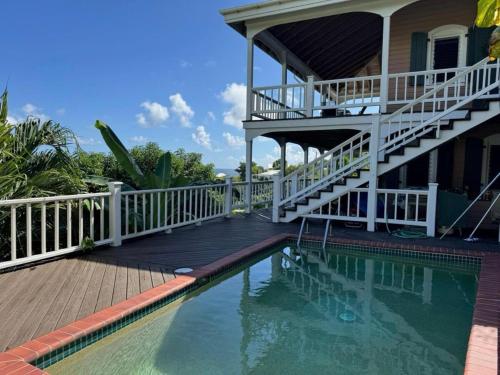 a house with a swimming pool in front of a house at Blue Pearl Villa in St John USVI in Coral Bay