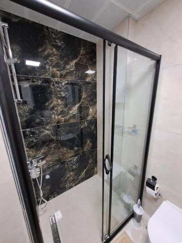 a shower with a glass door in a bathroom at Neridabeachhomes 20 in Alanya