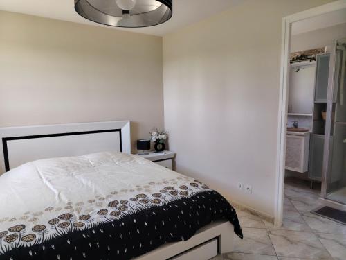 a bedroom with a bed with a black and white comforter at Villa Dolce Barbara in Tourbes
