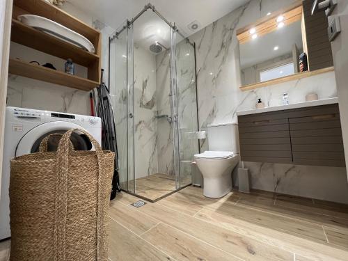a bathroom with a toilet and a glass shower at Corfu Port Sweet Studio in Mantoúkion