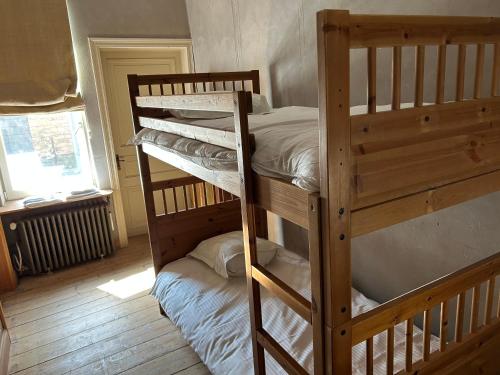 a bedroom with two bunk beds and a window at B&B 1669 in Bruges
