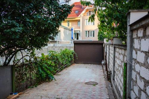 an alley with a gate and a building at Mary&George in Chişinău