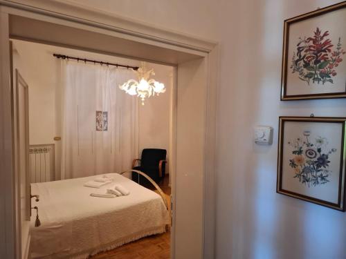 a bedroom with a bed and a chandelier at L'Olivo , in Tuscany in Bettolle