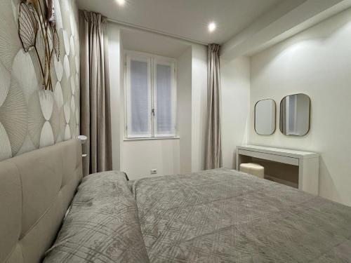 a bedroom with a bed and a window at Bella Como Holiday Apartment in Como