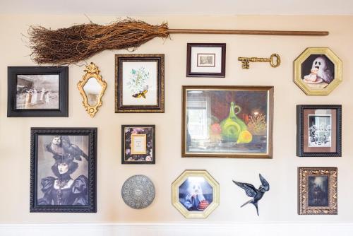 a wall of framed pictures on a wall at Ravens Hollow in Salem