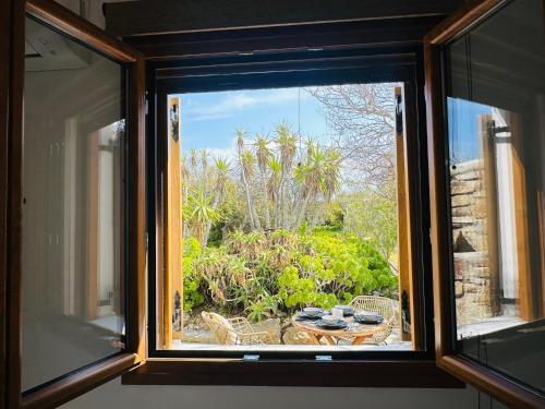 a window with a view of a table and a garden at Divers House in Agrari