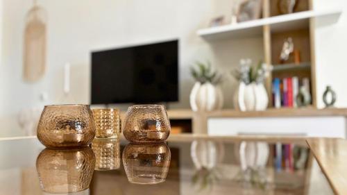 two glass containers sitting on a table in a living room at Oasis Centrale in Panteli