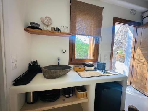 a kitchen counter with a sink and a bowl at Divers House in Agrari
