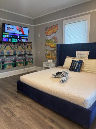 a bedroom with a bed with a dog laying on it at Nice & Cozy 3 bedroom Escape in Waycross