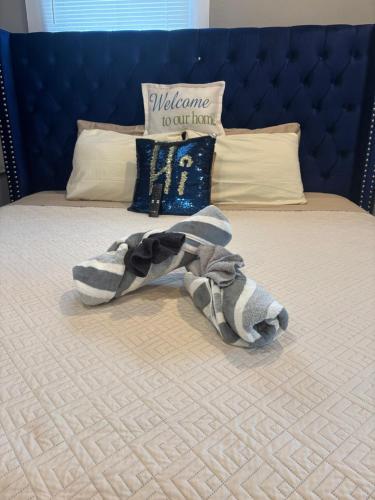 a bedroom with a bed with a towel on it at Nice & Cozy 3 bedroom Escape in Waycross