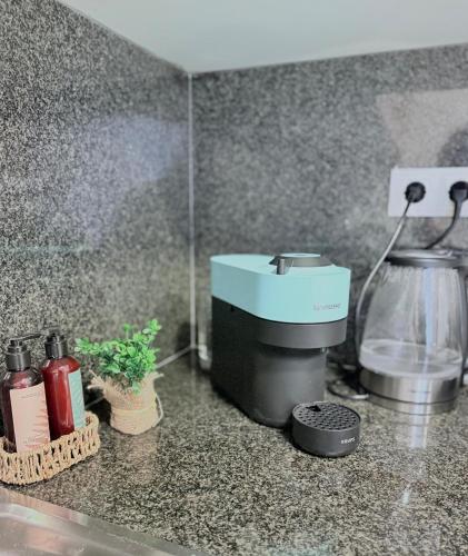 a kitchen counter with a coffee maker on it at Costa Suite Beach, Pool and Parking in Lloret de Mar