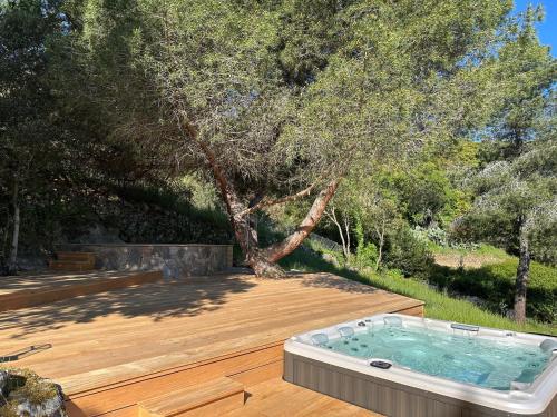 a hot tub sitting on top of a wooden deck at Casa Mimosa in Piana