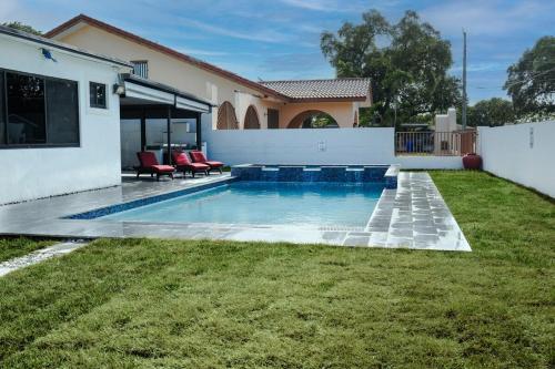 a swimming pool in the backyard of a house at Miami Freedom Park Oasis by H&S in Miami