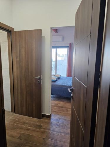 a room with a bedroom with a bed and a door at Modern Studio near Valletta and Sliema in Taʼ Xbiex