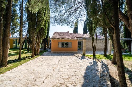 a house in the middle of a forest of trees at Vila Agava, Konavle in Gruda