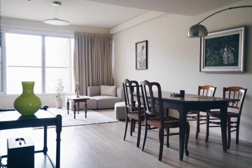 a living room with a dining room table and chairs at Chulin Homestay in Tainan