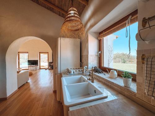 a kitchen with a sink and a large window at Monte de São Marco in Corte Paral