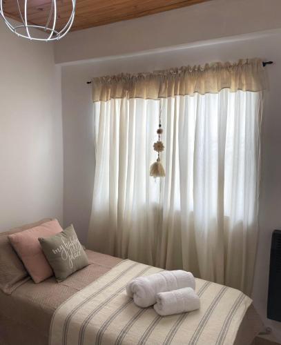 a bedroom with a bed with two towels on it at Habitación Independiente Azul in Azul