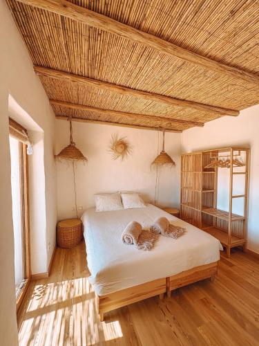 a bedroom with a bed with a wooden ceiling at Monte de São Marco in Corte Paral