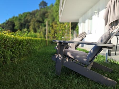 a pair of chairs sitting under an umbrella in the grass at VILLA AGA in Noli