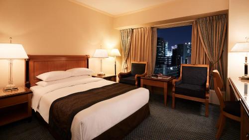 a hotel room with a large bed and a window at RIHGA Royal Hotel Osaka, Vignette Collection by IHG in Osaka