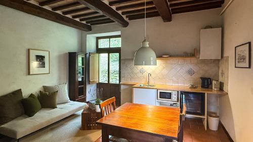 a kitchen and living room with a table and a couch at Bio Agriturismo Il Vigno in Caprese Michelangelo