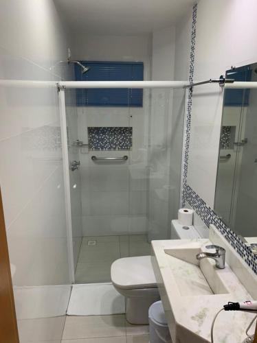 a bathroom with a shower and a toilet and a sink at Prudentópolis Palace Hotel in Prudentópolis