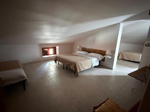 a bedroom with two beds and a couch in it at Palazzo 1815 in Papasidero