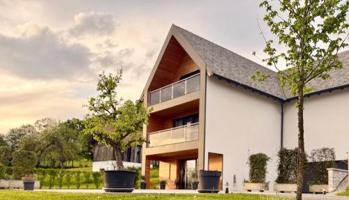 a white house with a black roof at KOASA HOF Bed and Breakfast in Oberhaag