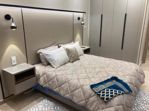 a bedroom with a large bed with pillows on it at Location appart Oran Akid lotfi & Canastel in Oran