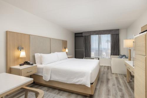 a hotel room with a large bed and a window at Holiday Inn Resort Galveston - On The Beach by IHG in Galveston