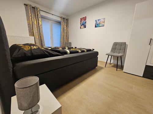 a bedroom with a bed and a chair at Apartment Rückertstraße in Nordhausen