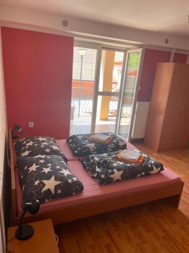 a bedroom with a bed with two pillows on it at Penzión Bernáth in Rožňava