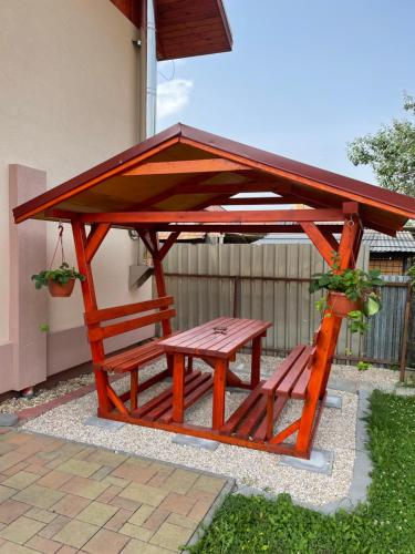 a picnic table and bench under a pavilion at Penzión Bernáth in Rožňava