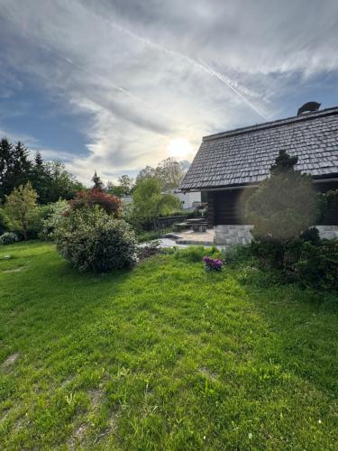 a house with a yard with a grass field at Alice Chalet Bled - Adults only in Bled