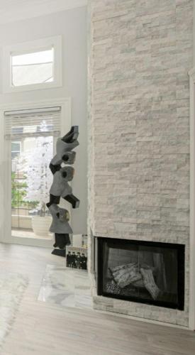 a fireplace in a living room with a brick wall at CLOUD NINE - Elegance & Comfort in Irvine