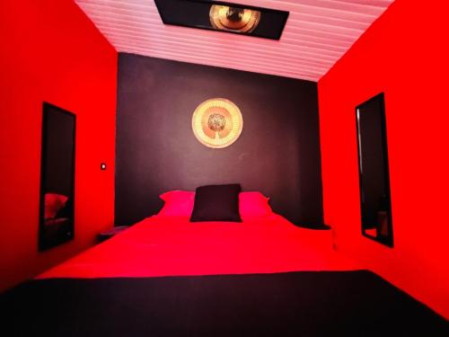 a red bedroom with a bed with red lighting at Love Room by Orcéa & Spa in Sainte-Anne