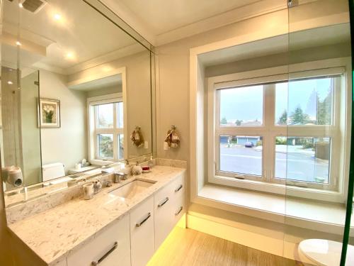 a bathroom with a sink and a large window at Vancouver Shangrila House in Richmond
