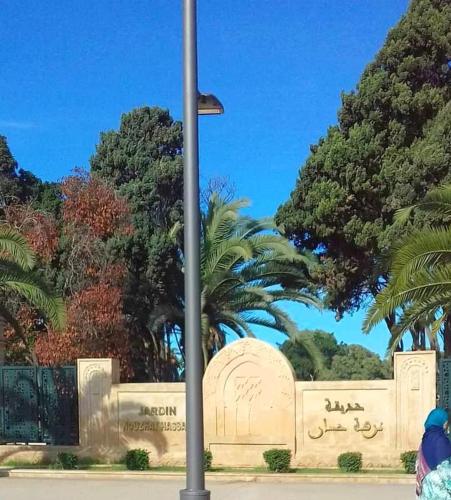 a street light in front of a monument with trees at Urban Gateway Heart Of RABAT in Rabat