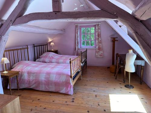 Postel nebo postele na pokoji v ubytování La Buissonnière