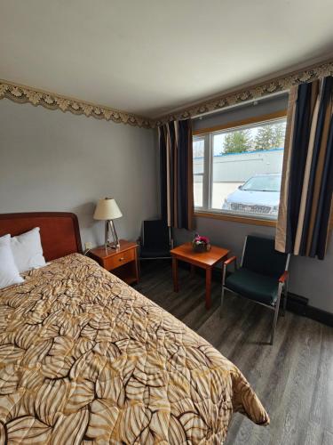 a hotel room with a bed and a window at Forest Plaza Motel in Mount Forest