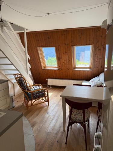 a living room with a table and chairs at Cosy Nest in Bovec